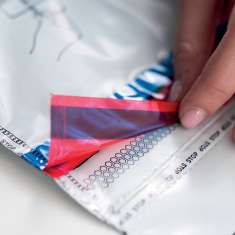Person Tearing Back the Red and blue Foil Seal on a Snack Bag close up filename  Eurosecuritybg