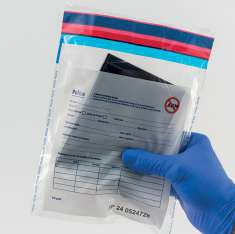 Gloved Hand Holding a Sealed Plastic Bag Containing a Paperwork Form Inside As Used for a Lab Sample Kit filename  Eurosecuritybg